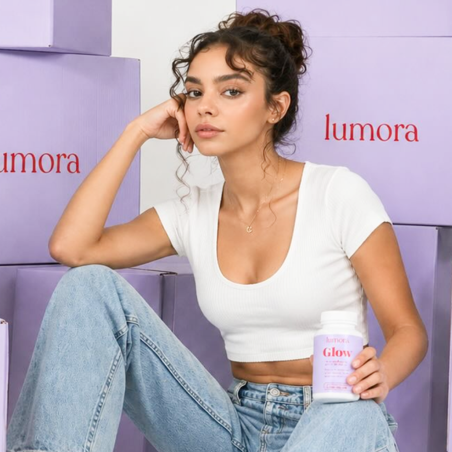 Woman sitting with Lumora product boxes